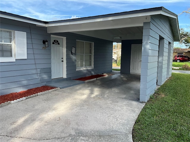 property entrance with a carport