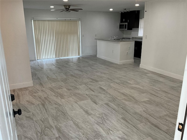 unfurnished living room featuring ceiling fan