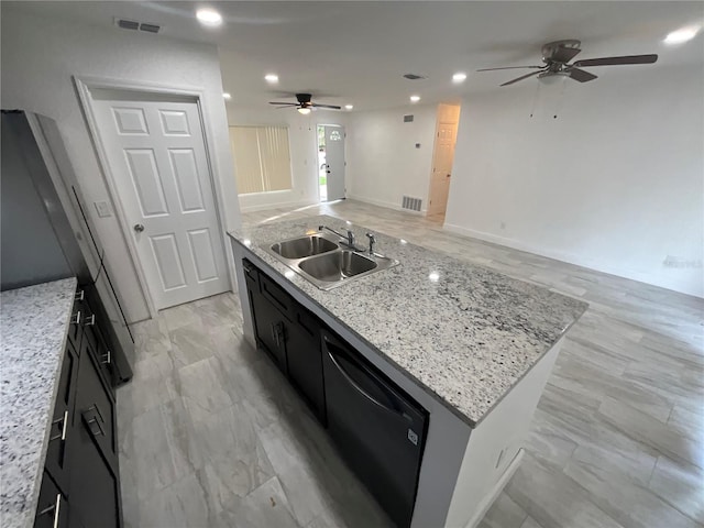 kitchen with black dishwasher, light stone countertops, sink, a center island, and ceiling fan