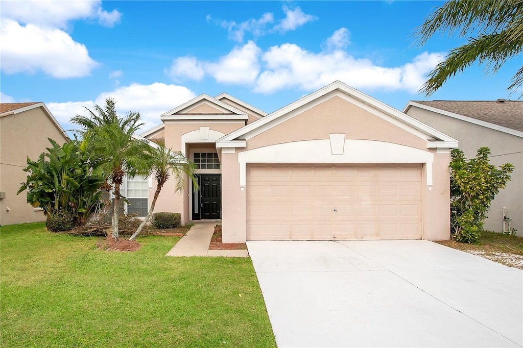 ranch-style home featuring a garage and a front yard