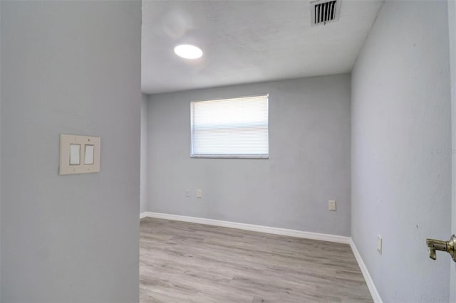 spare room featuring light hardwood / wood-style floors