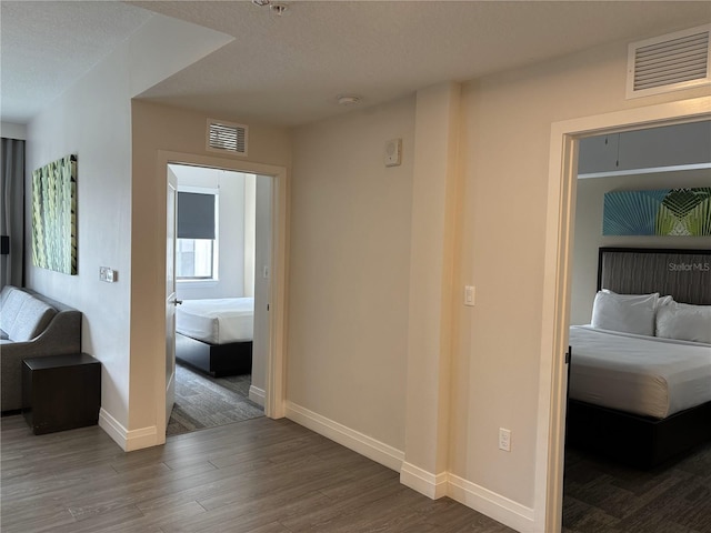 14501 Grove Resort Ave Unit 2608, Winter Garden, FL 34787 - hallway with wood finished floors, baseboards, and a textured ceiling