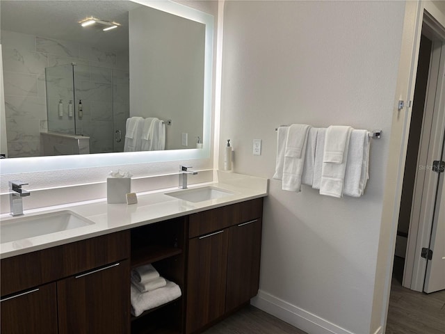 14501 Grove Resort Ave Unit 2608, Winter Garden, FL 34787 - full bathroom featuring double vanity, a marble finish shower, wood finished floors, and baseboards