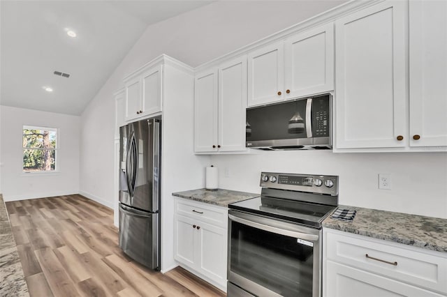 kitchen featuring appliances with stainless steel finishes, light hardwood / wood-style flooring, white cabinetry, and vaulted ceiling