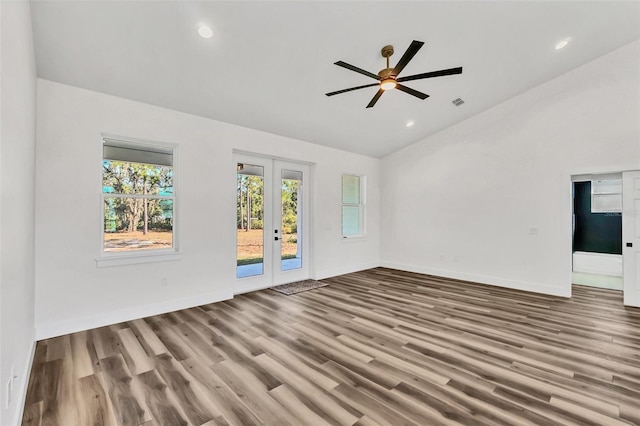 unfurnished living room with french doors, hardwood / wood-style floors, ceiling fan, and vaulted ceiling