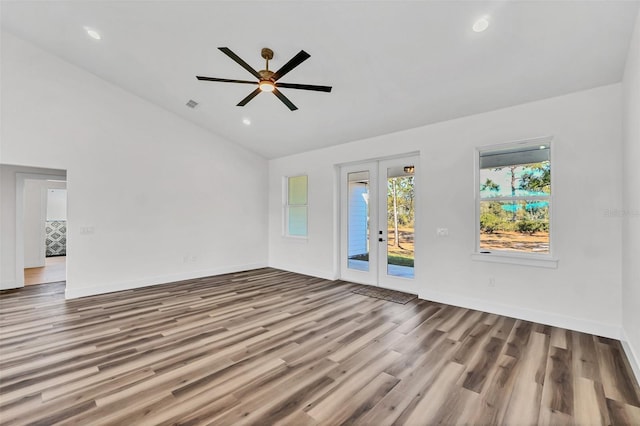 unfurnished living room with french doors, ceiling fan, high vaulted ceiling, and wood-type flooring