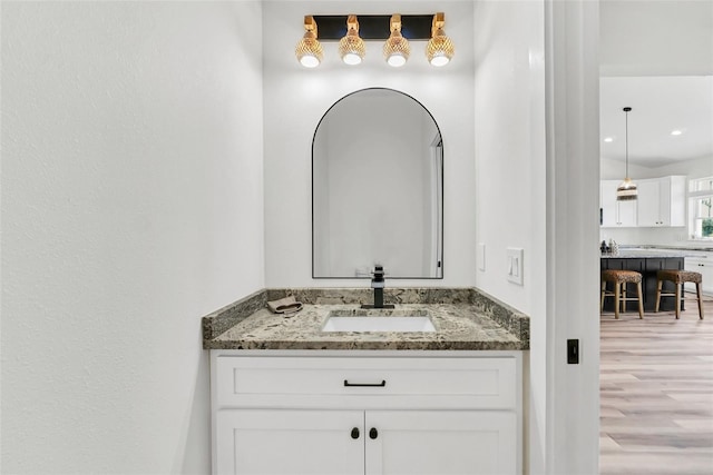 bathroom with vanity and hardwood / wood-style floors