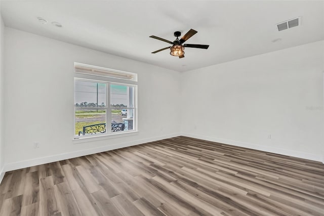 spare room featuring light hardwood / wood-style flooring and ceiling fan