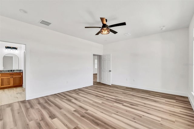 empty room with light hardwood / wood-style flooring and ceiling fan