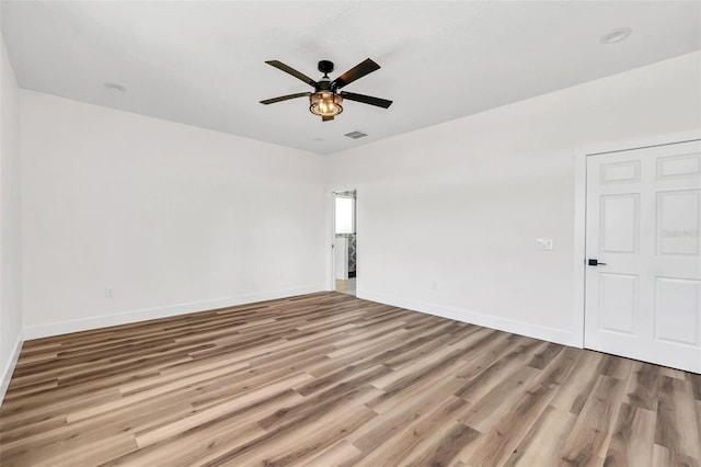 empty room with light hardwood / wood-style floors and ceiling fan