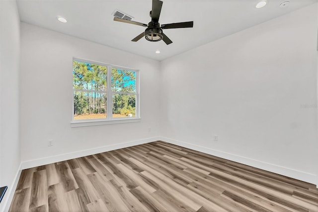 spare room featuring light hardwood / wood-style flooring and ceiling fan