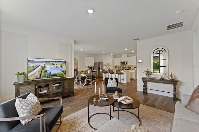 living room with light hardwood / wood-style flooring