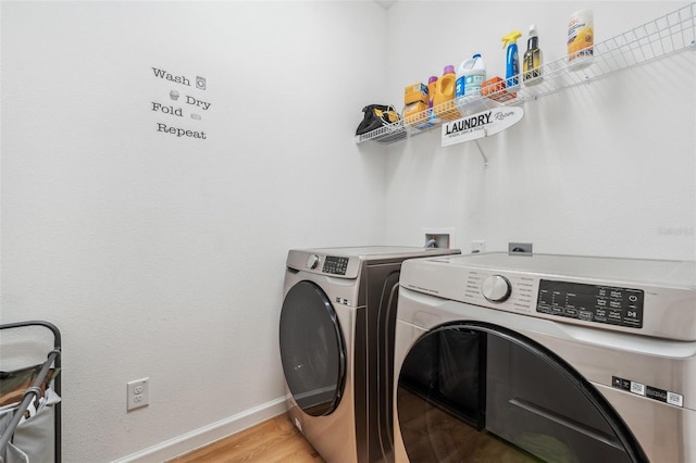 washroom with light wood-type flooring and separate washer and dryer