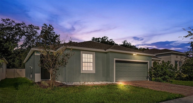 view of front of house with a yard and a garage