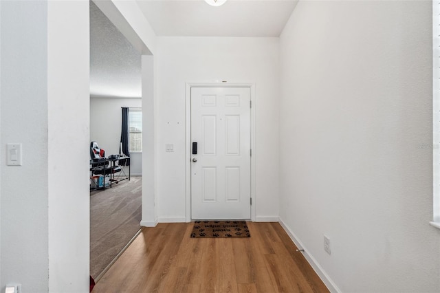 foyer featuring a textured ceiling and hardwood / wood-style flooring