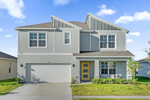 view of front of property with a front lawn and a garage