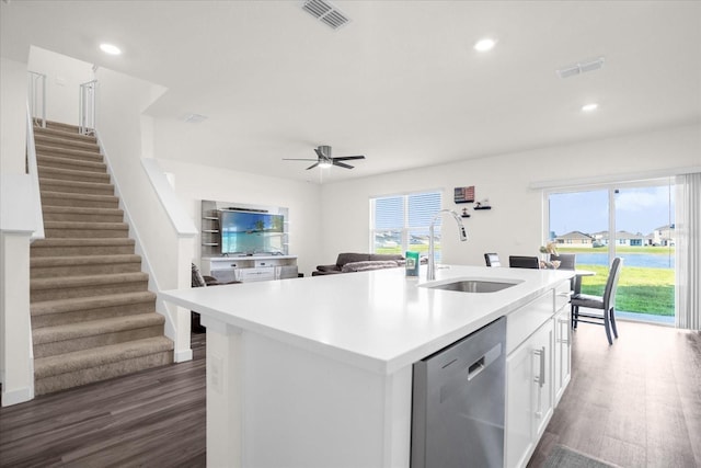 kitchen featuring stainless steel dishwasher, sink, an island with sink, and plenty of natural light