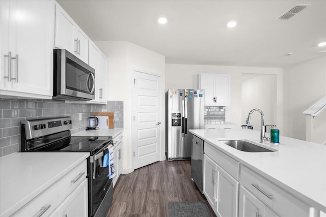 kitchen with white cabinetry, stainless steel appliances, and sink