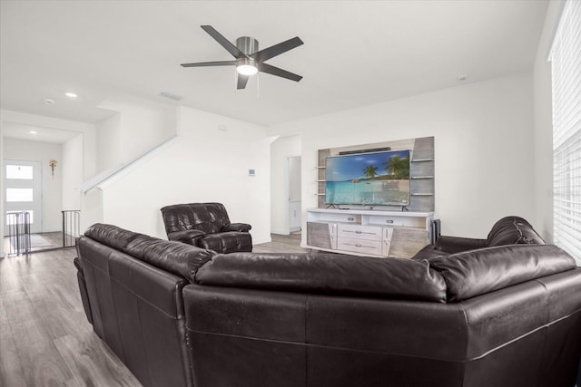 living room featuring wood-type flooring and ceiling fan