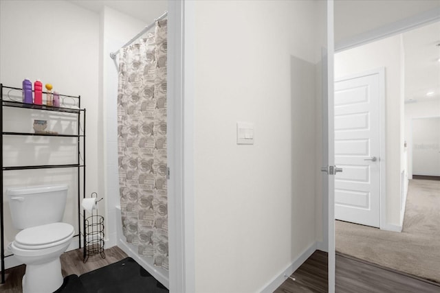 bathroom with wood-type flooring and toilet