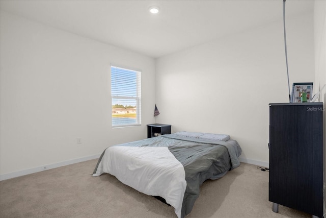 bedroom featuring light colored carpet