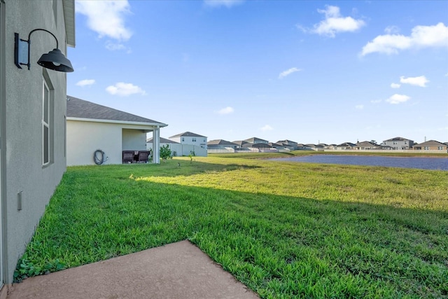 view of yard with a patio area and a water view