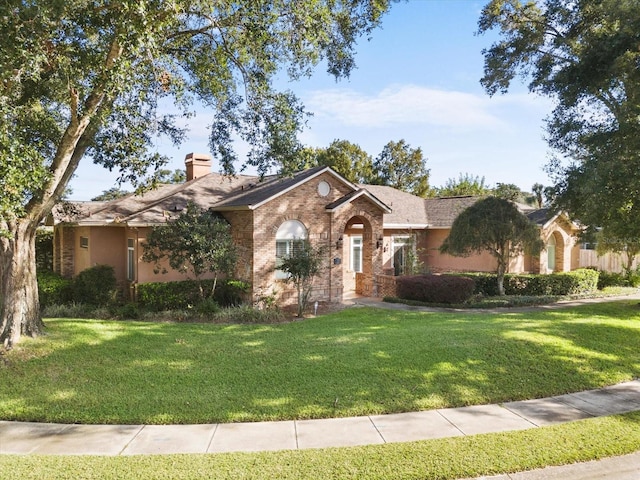 ranch-style home featuring a front yard