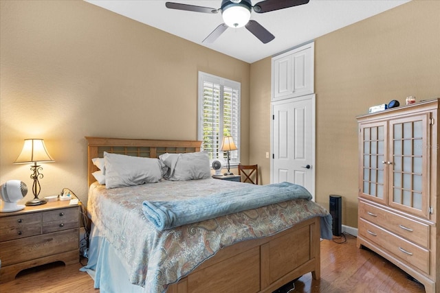 bedroom featuring hardwood / wood-style floors and ceiling fan