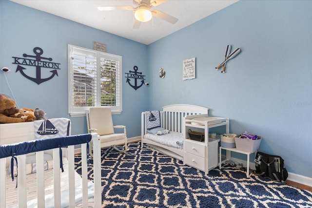 bedroom with a crib and ceiling fan