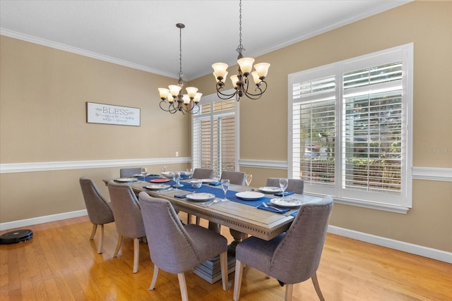 dining room with ornamental molding, a chandelier, and light wood-type flooring