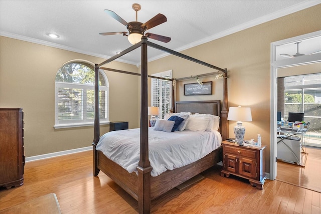 bedroom with ceiling fan, crown molding, multiple windows, and light wood-type flooring