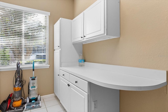 laundry area with light tile patterned floors