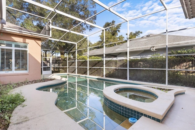 view of pool with a lanai and an in ground hot tub