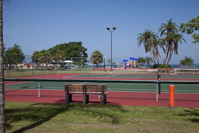 view of sport court with a yard