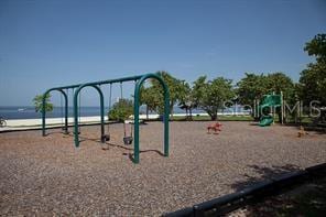 view of play area with a view of the beach and a water view