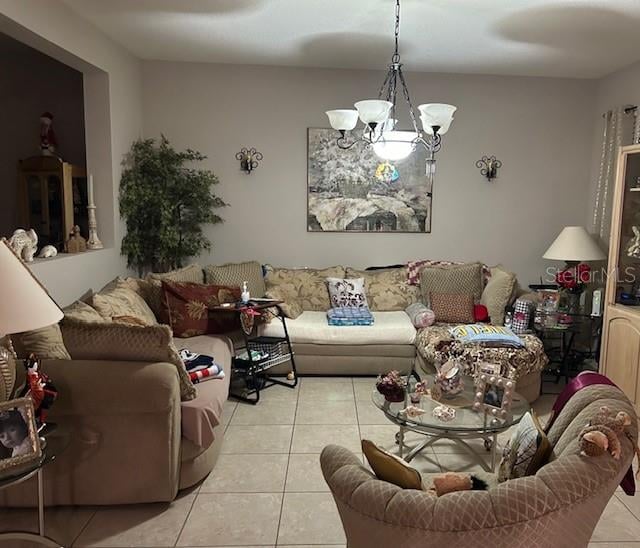 tiled living room featuring a notable chandelier