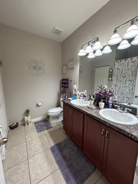 bathroom with vanity, tile patterned floors, and toilet