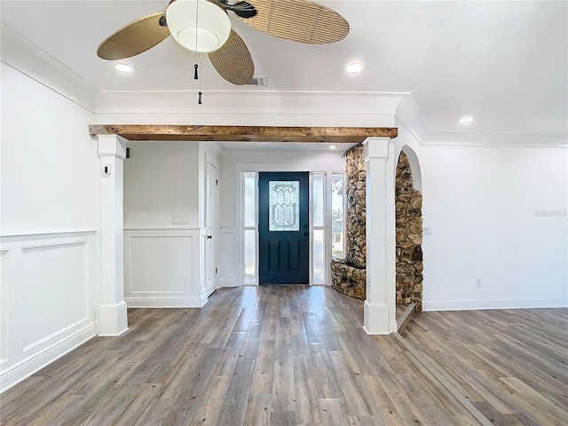 entryway with ornamental molding, hardwood / wood-style flooring, and ceiling fan