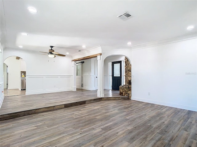 unfurnished living room featuring ornamental molding, hardwood / wood-style flooring, and ceiling fan