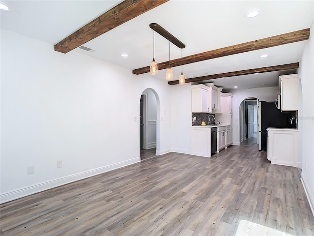 kitchen featuring decorative backsplash, hardwood / wood-style floors, white cabinetry, pendant lighting, and sink