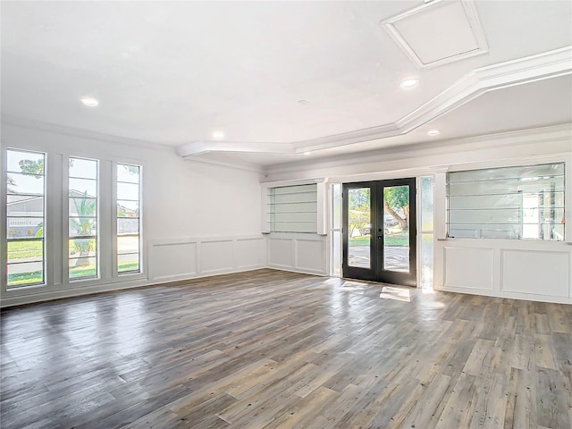 unfurnished room featuring french doors, ornamental molding, and wood-type flooring