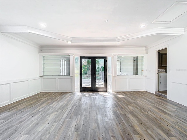 unfurnished room with french doors, wood-type flooring, washer / clothes dryer, and ornamental molding