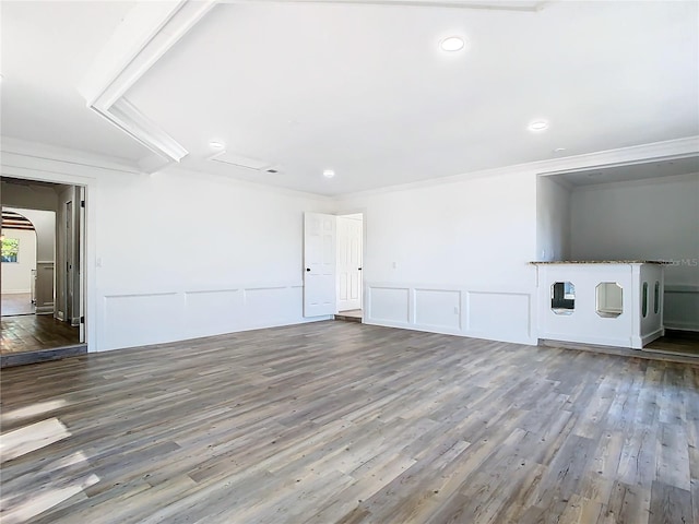 unfurnished living room featuring ornamental molding and hardwood / wood-style floors