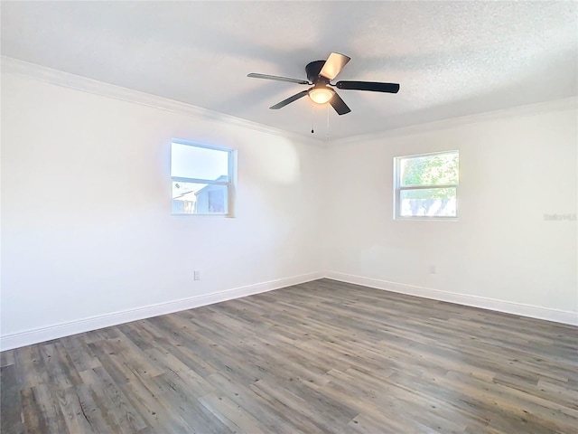 spare room featuring crown molding, dark hardwood / wood-style flooring, and ceiling fan