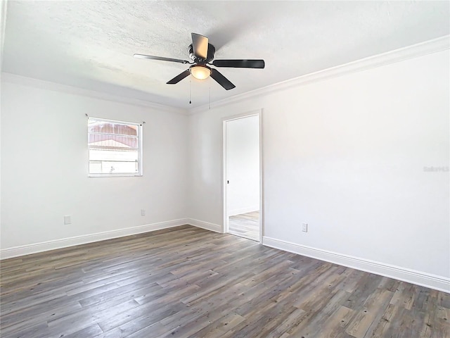 spare room featuring ornamental molding, dark wood-type flooring, a textured ceiling, and ceiling fan