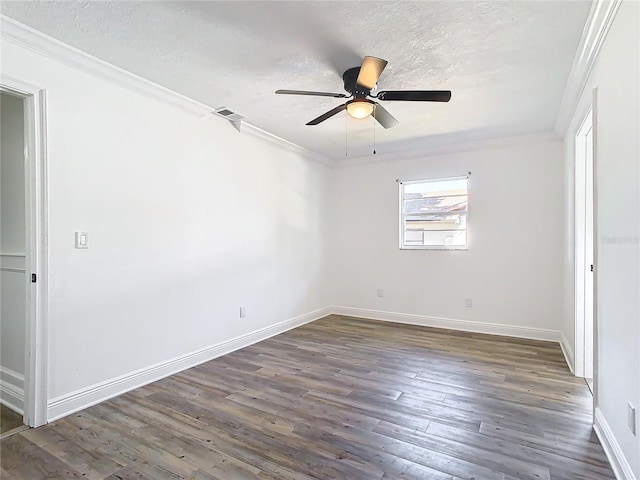 spare room with dark wood-type flooring, ceiling fan, crown molding, and a textured ceiling