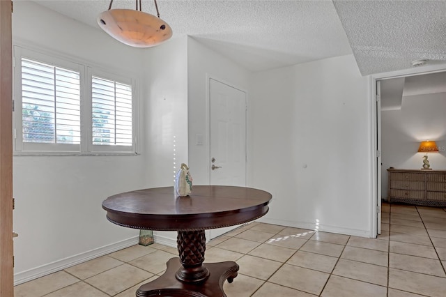 entryway featuring a textured ceiling and light tile patterned floors