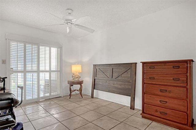 interior space with ceiling fan, a textured ceiling, and multiple windows