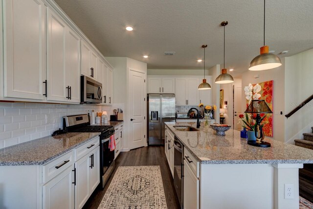 4009 Winding Meadows St, Apopka, FL 32712 - kitchen with a sink, dark wood-style flooring, visible vents, white cabinets, and appliances with stainless steel finishes