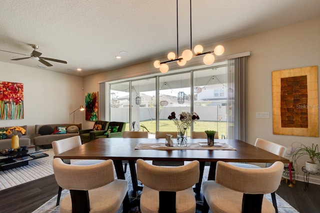 dining area featuring a textured ceiling, hardwood / wood-style flooring, and ceiling fan